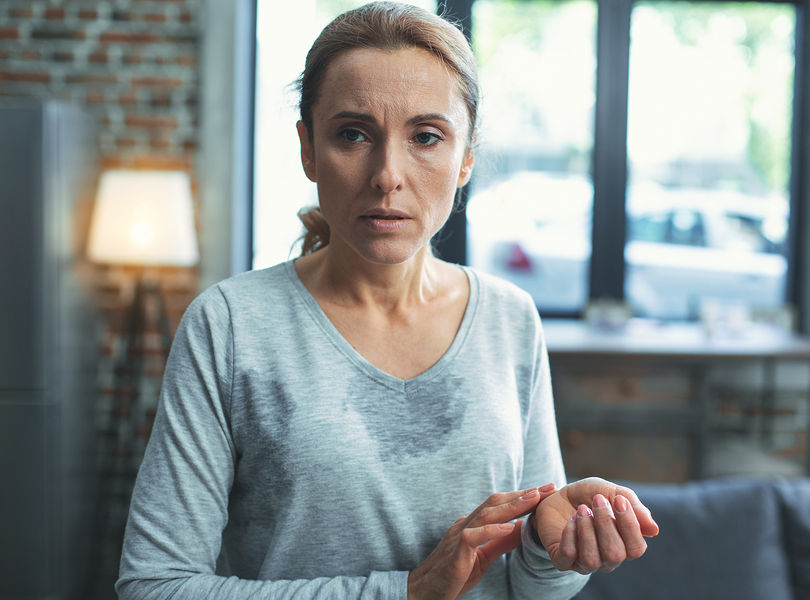 An image of Marie suffering from menopausal symptoms who's case highlights how symptoms can sometimes disappear in reverse chronological order.