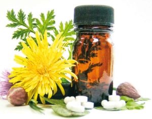 A decorative image of a liquid homeopathic bottle and some pills