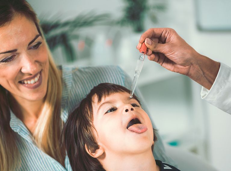 A happy little boy taking homeopathic drops