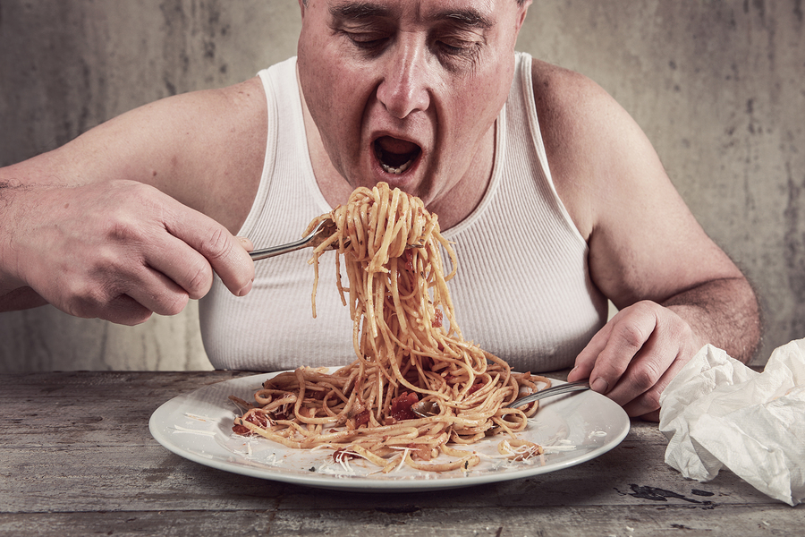 Man eating spaghetti, overeating adult.