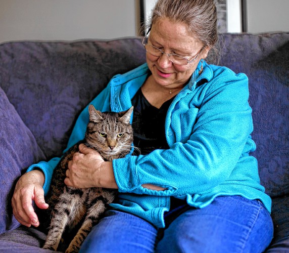 Wendy Jensen with her own cat Jowy in her Bow home recently. (GEOFF FORESTER / Monitor staff)