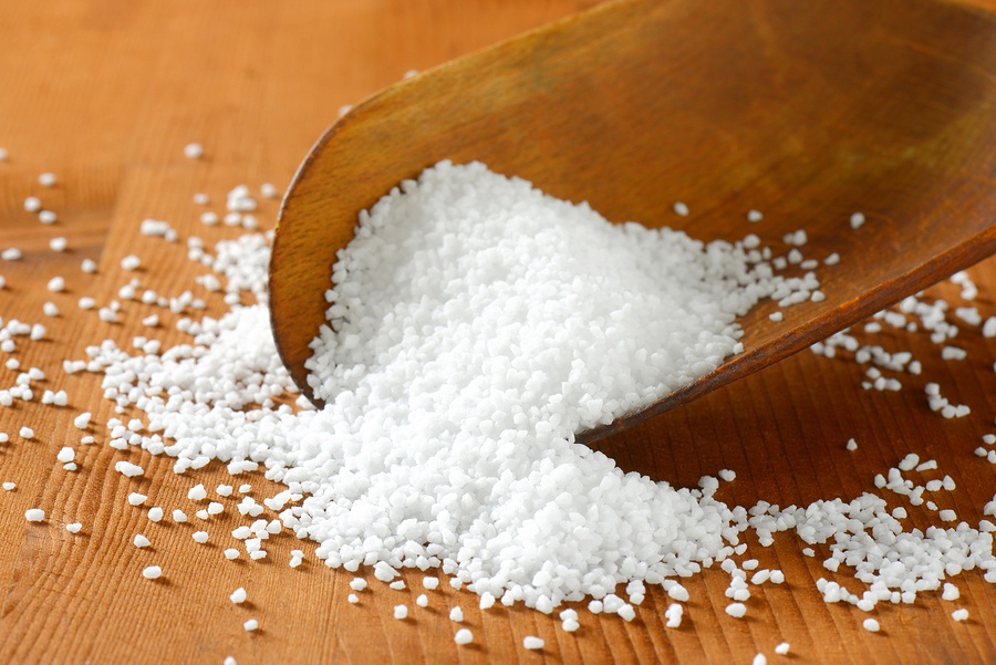 Coarse grained salt on a wooden scoop