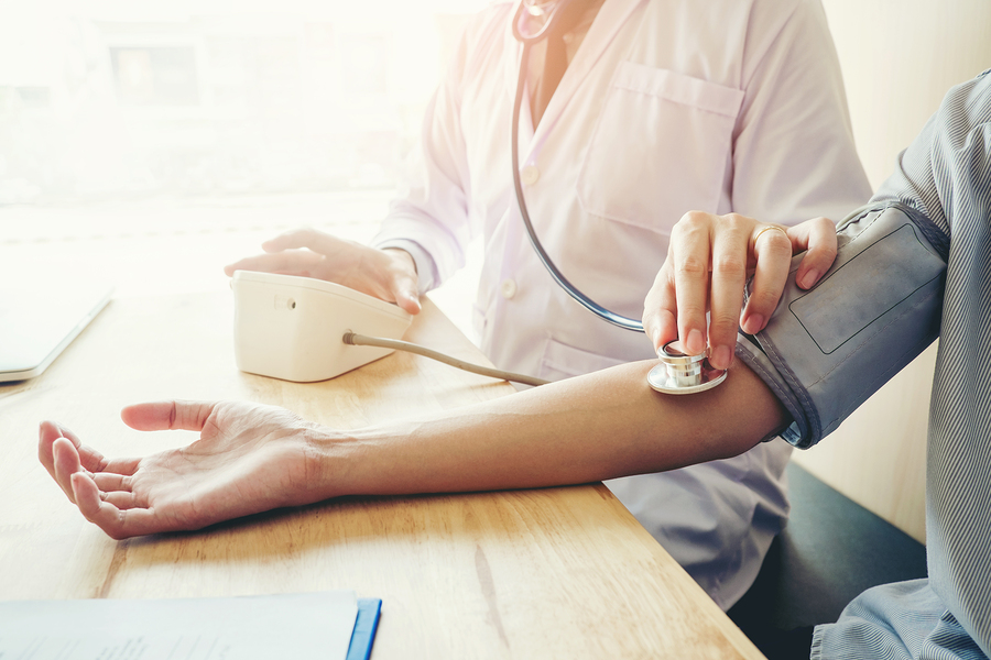 A doctor taking someone's blood pressure