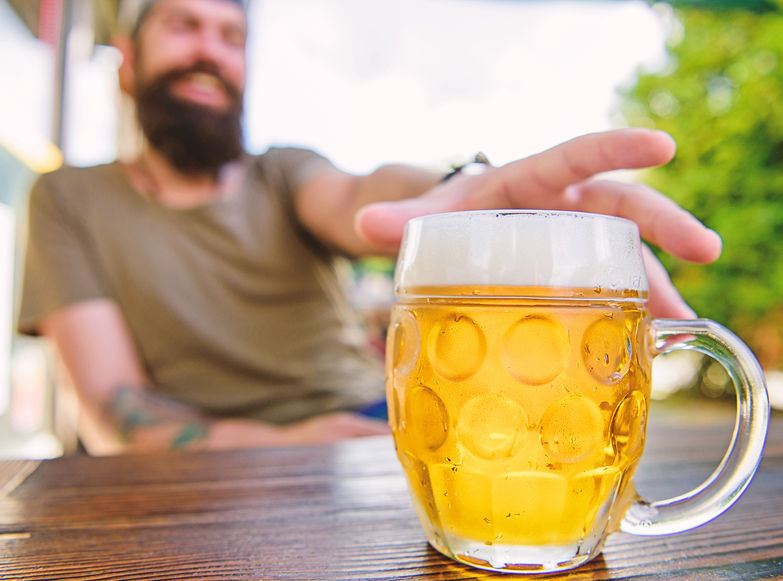 A man reaching for a beer 