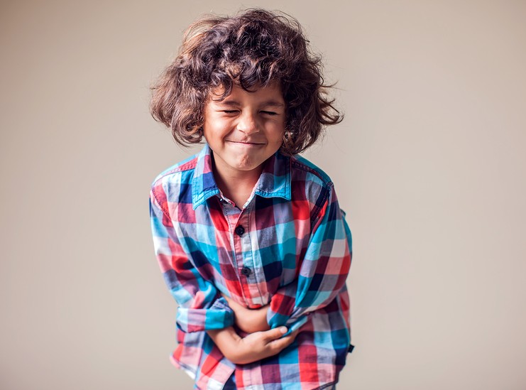 An image of a little boy in discomfort from diarrhea for this article on research into homeopathy for diarrhea. 