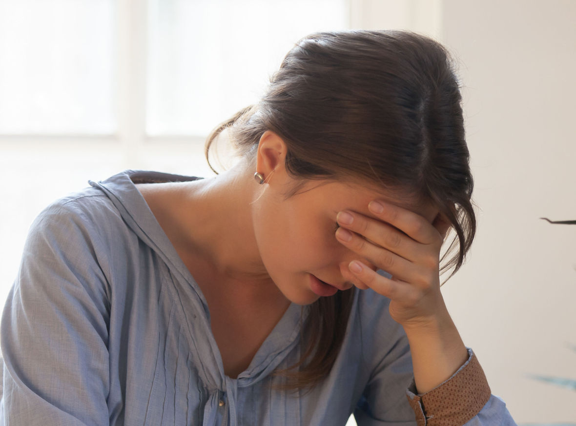 Mary with her head in her hands who is suffering from grief and trauma